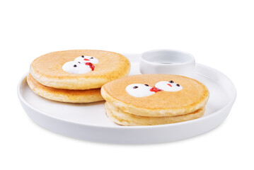 Pancakes with marshmallow snowmen in a plate for Christmas holidays on a white isolated background