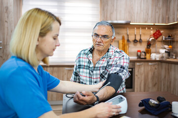 Health check with caring nurse at home setting