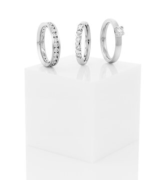 Still life of wedding rings on a white pedestal