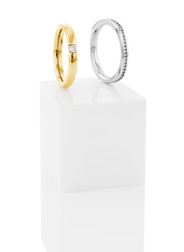 Still life of wedding rings on a white pedestal