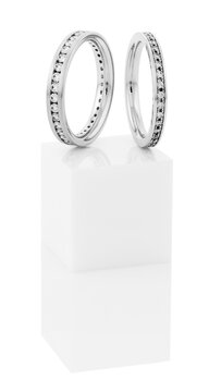 Still life of wedding rings on a white pedestal