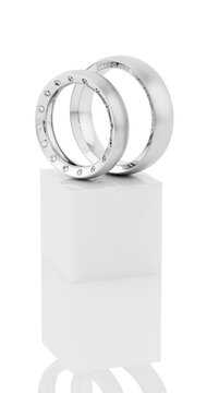 Still life of wedding rings on a white pedestal