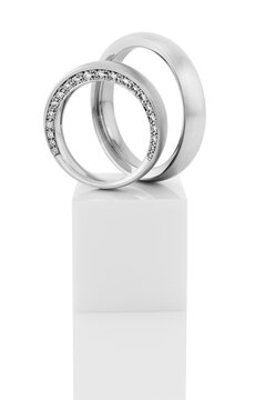 Still life of wedding rings on a white pedestal