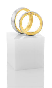 Still life of wedding rings on a white pedestal