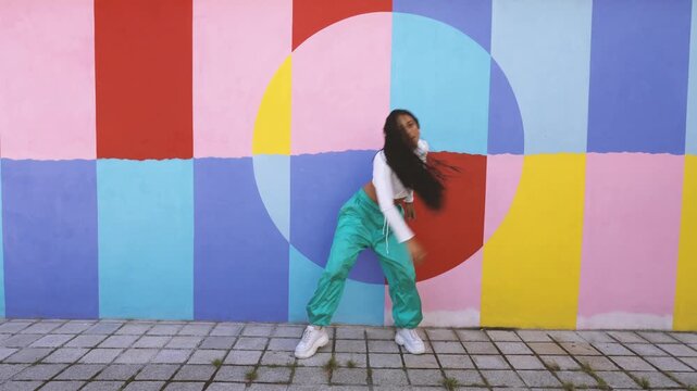 Young energetic woman dancing hip hop style