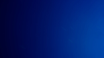 A blurred, grainy, gradient sky background, light blue.