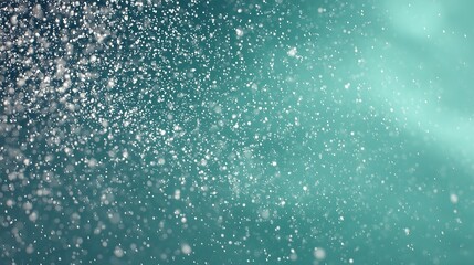 Obraz premium Sparkling abstract particles drift across a cool teal background