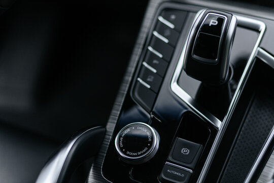 Close-Up Of Modern Car Center Console With Gear Shifter And Drive Mode Dial
