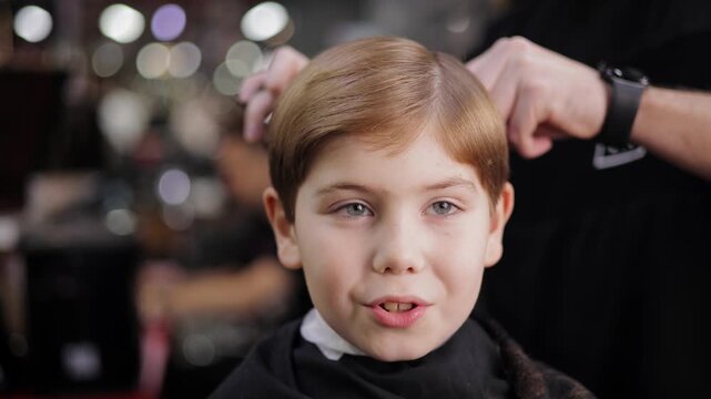 Caucasian young boy's haircut session in modern barber shop, banner retro barbershop for kid.