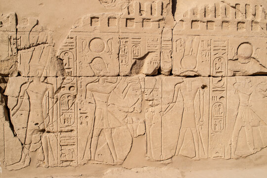 Ancient Egyptian hieroglyphs on stone wall, Karnak Temple Complex, Luxor, Egypt, Africa. Stone carvings with hieroglyphs at Karnak temple, Luxor, Thebe