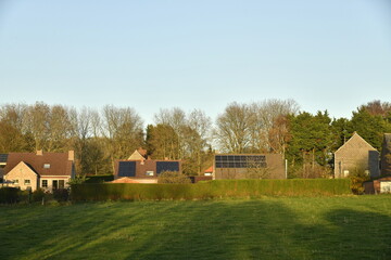 Lumière du coucher de soleil sur les prairies et maisons à Marche-Lez-Écaussinnes (Soignies)