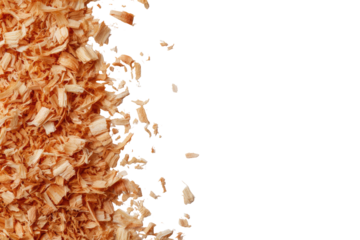 Close-up of light brown wood shavings.  Some shavings are falling from a pile