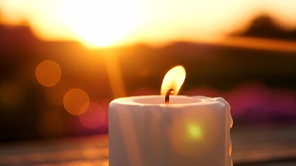 A white candle burns softly as the sun sets, casting a warm glow in the evening light. The candle's flickering flame and the sunset create a peaceful atmosphere around the candle. - Powered by Adobe