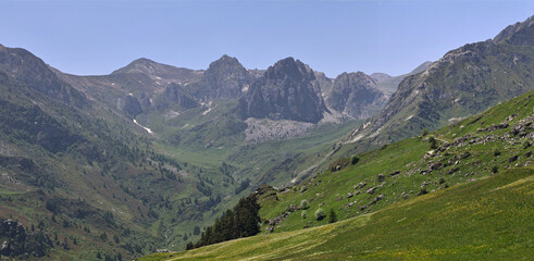 The view of the Alps in Valle Grana, Italy, reveals majestic mountain scenery with snowy peaks and verdant valleys. It is the perfect place for tranquillity and inspiration.