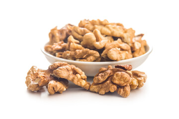 Peeled walnut kernels in bowl isolated on white background.