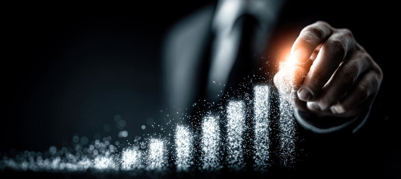 Businessman hand creating glowing bar chart growth