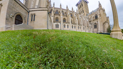 Detailed view of the Washington National Cathedral wall and lawn on a cloudy day