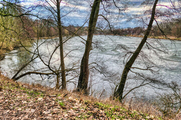 a pond on the Cybina River route covered with ice during winter