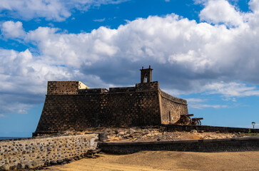 Stone castle with cannons on display at Arrecife, Lanzarote, Canary Islands. Historical fortress and stunning ocean backdrop