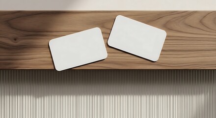 Two blank business cards with rounded corners on a wooden shelf, a minimalist mockup for branding identity and presentation