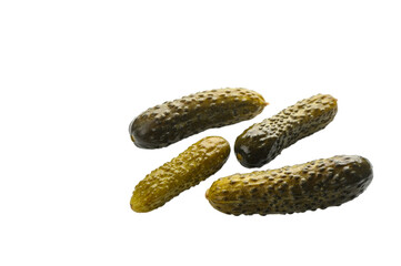 Four barrel-salted cucumbers on white background