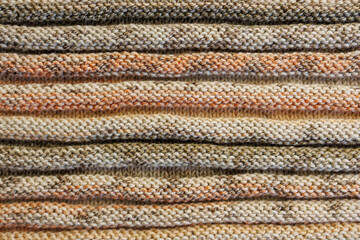 Fototapeta premium Knitted Fabric Texture with Warm Multicolor Stripes, Close-Up Background