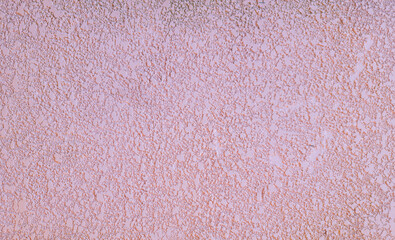 a soft lilac background with a decorative plaster effect on the surface. space for text