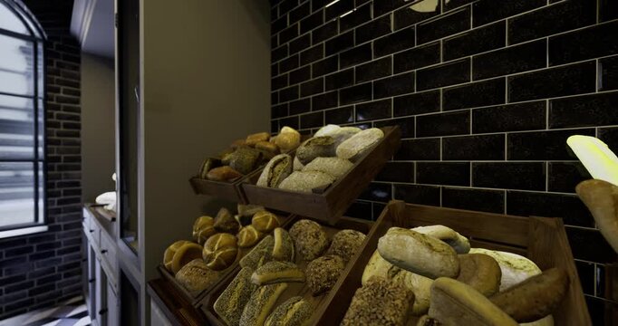 A variety of freshly baked bread types fill wooden trays in a sleek bakery. The dark tiled walls enhance the appealing presentation of loaves, rolls, and baguettes.