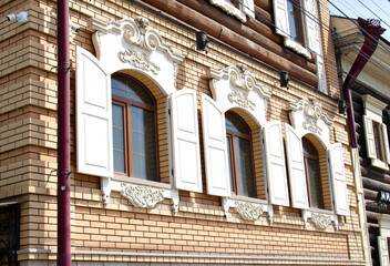 Decorative antique plaster on the facade of the building above the window