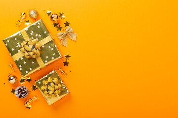 Golden gift boxes and decor on color background, top view