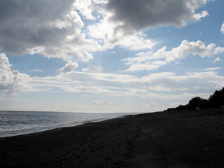 Summer landscape - sea with black sand on the island of Santorini