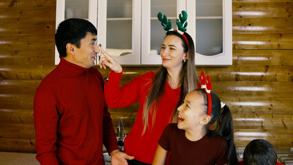 A family is baking Christmas cookies together in the kitchen