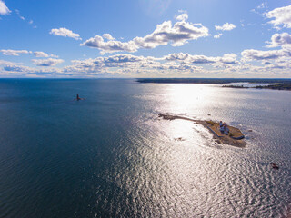 Aerial view of Whaleback Lighthouse on the left and Wood Island Life Saving Station on the right at sunset in Portsmouth Harbor in town of Kittery, Maine ME, USA. 