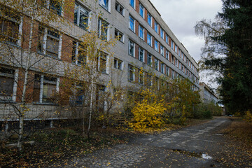 Abandoned white brick multistory houses, decaying cityscape of ghost town