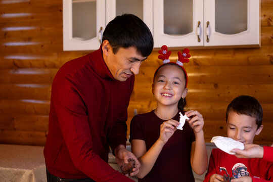 Man and children enjoying cake together for Christmas.