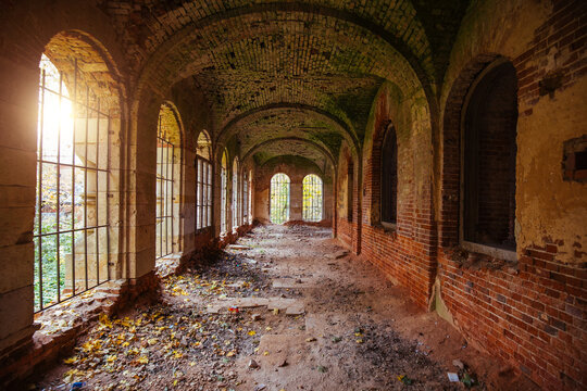 Corridor of old ancient abandoned red brick ruined historical building.