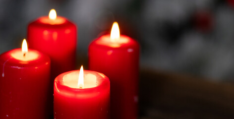 candles burning against holiday lights background