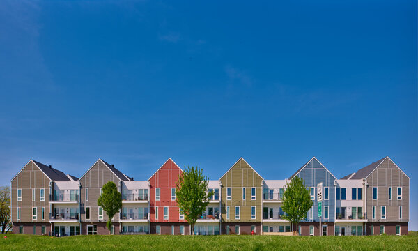 Apartments,condominiums, green space and bike paths in an area of urban expansion. Solutions for more housing. Colorful buildings and blue sky.