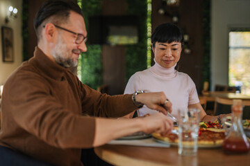 Diverse couple enjoying a romantic lunch date at restaurant