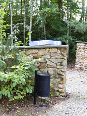 trash can and restroom sign