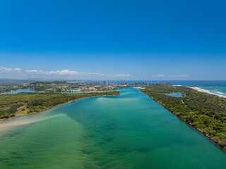 Elevated aerial sunset views of  the Tweed River inlet with the Coolangatta and Tweed Heads skyline visible in the background, New South Wales, Australia