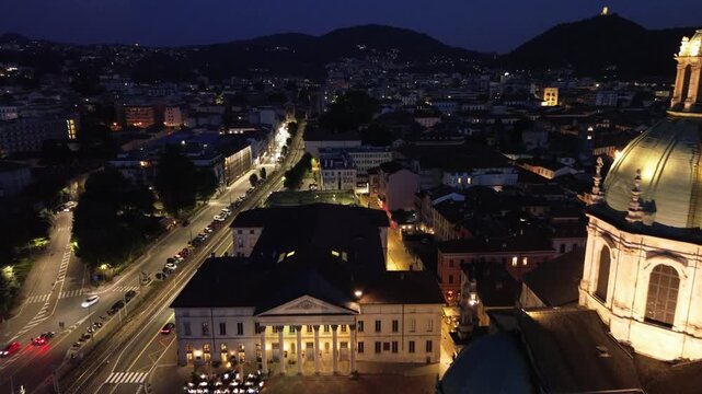 nocturnal aerial view of Como Cathedral illuminated with cinematic lights showcasing the intricate details of the dome from above 5