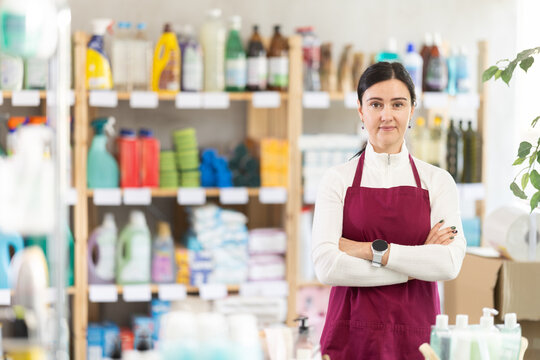 Female saleswoman friendly invites to shop in the household department of a supermarket. Best seller offers purchases on promotions and new arrivals