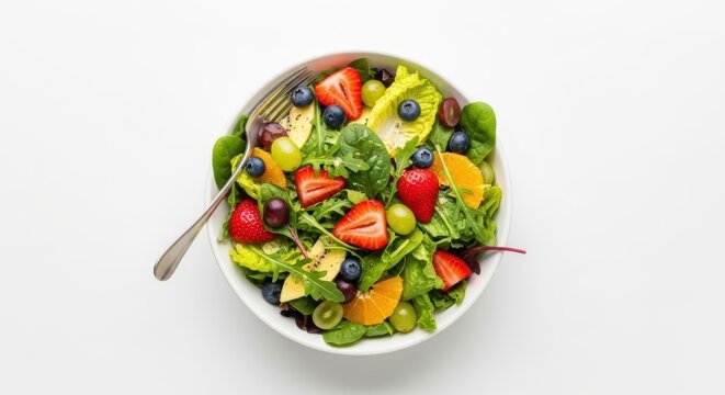 Brighten your day with a vibrant fruit salad featuring juicy strawberries, blueberries, and kiwi in a bed of fresh greens for a healthy lifestyle