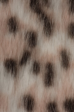 Vertical photo of fur. Texture of faux fur under a leopard, macro photo as a background.