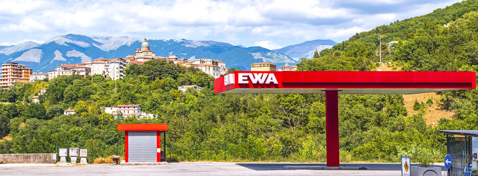 EWA gas station along the Sora-Cassino road in the Italian Lazio region,with historical center of Atina town in the background,wide shot.