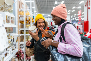 Happy couple shopping for home decor gifts in store aisles