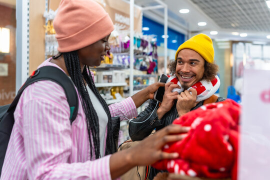 Young couple happily shopping for travel essentials in store