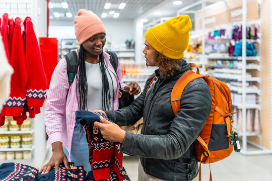 Diverse friends shopping for winter christmas sweaters