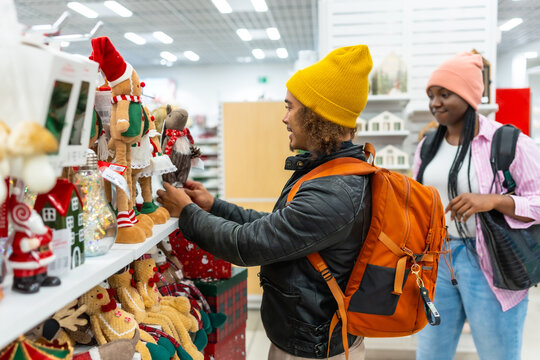 Young couple shopping for festive christmas decorations in retail store